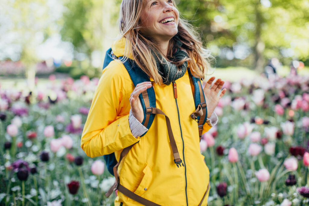 Junge Frau lachend beim Wandern im Frühling